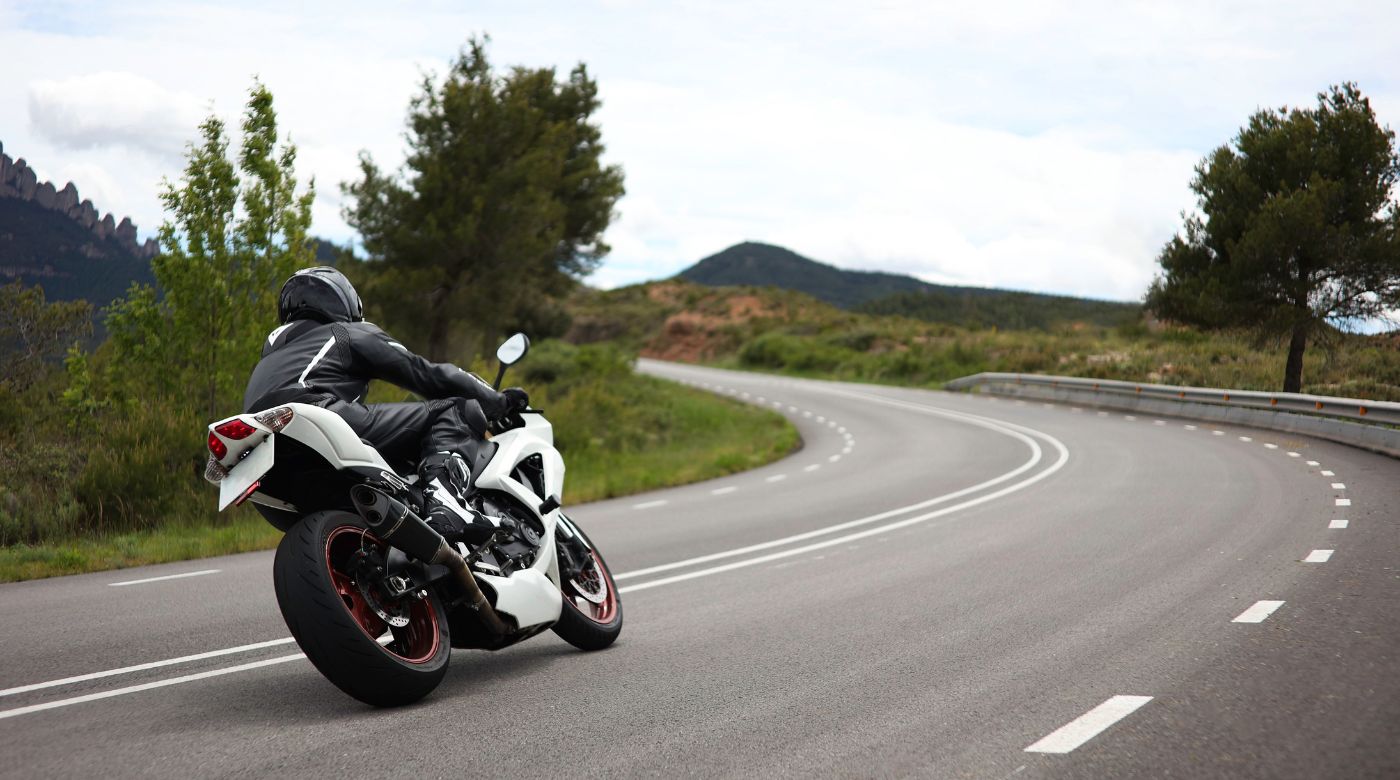 man leaning on motorcycle