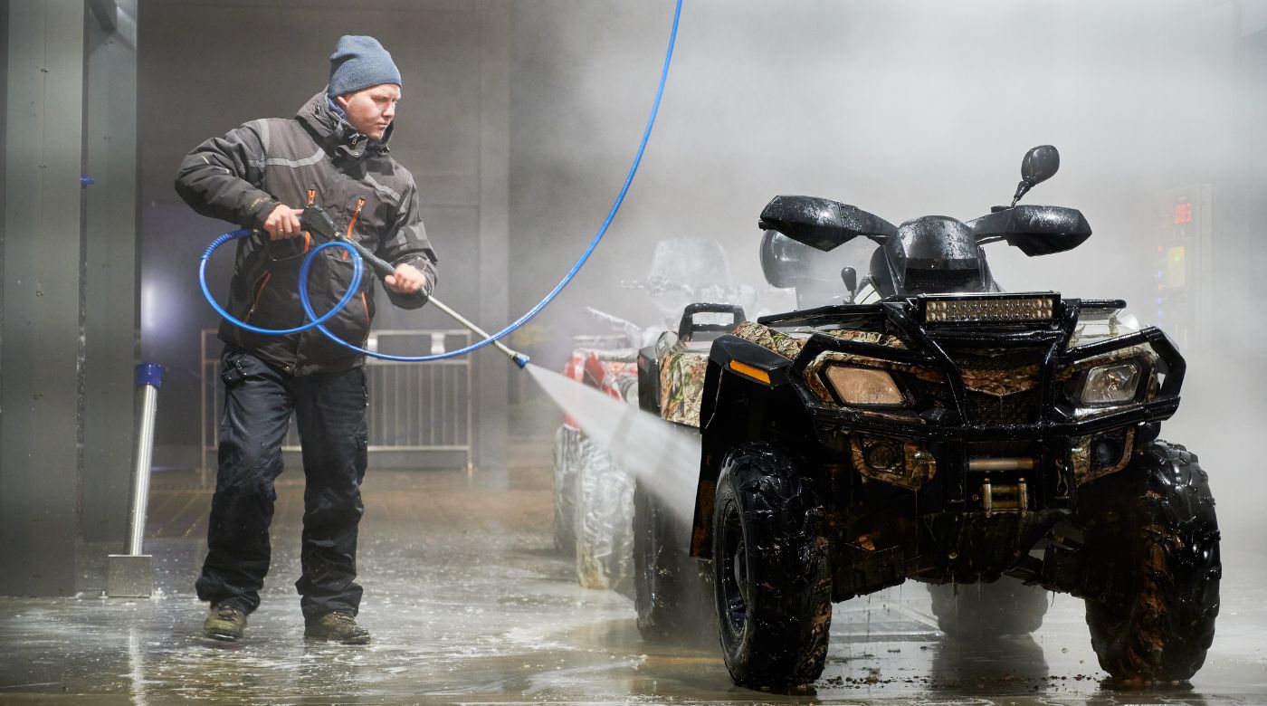 man washing ATV