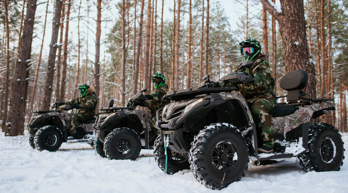 Three quad bikes in the forest in winter