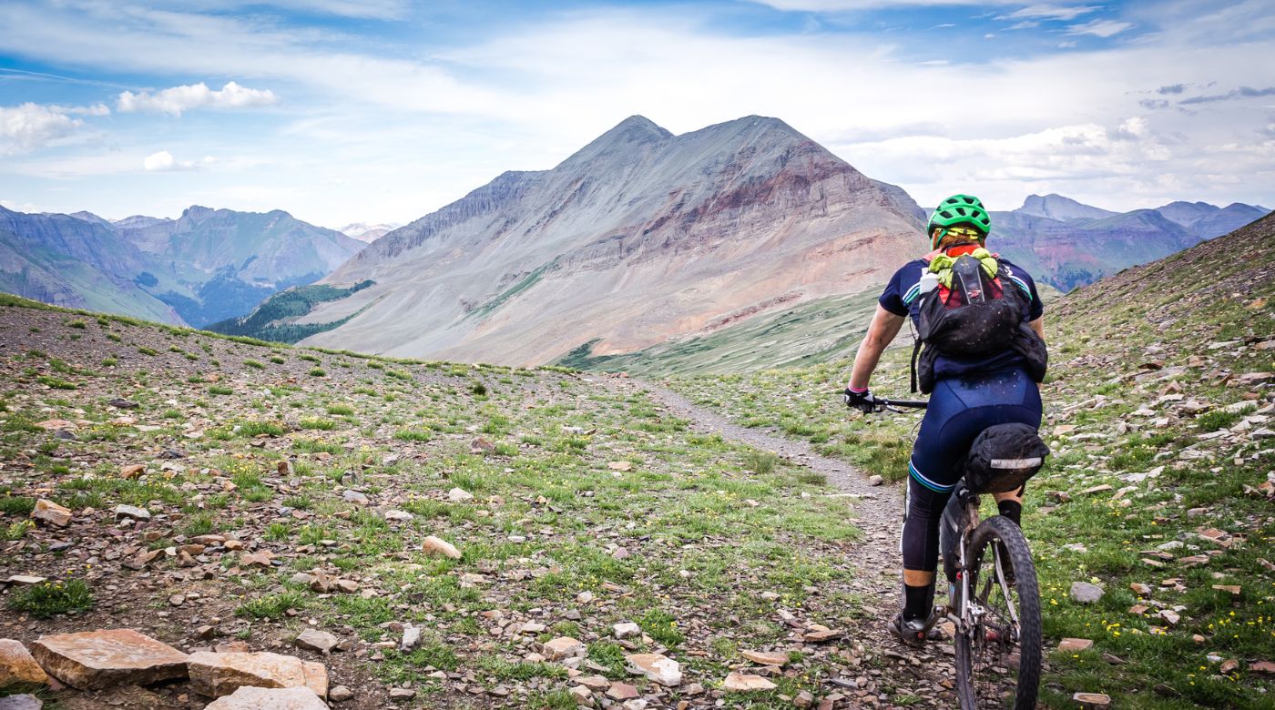 man mountain biking in colorado