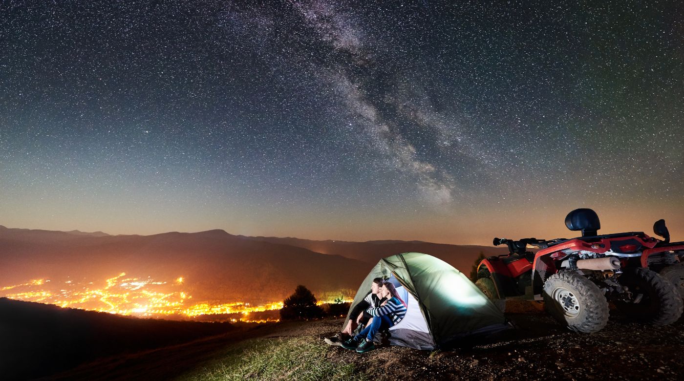 couple sit under stars