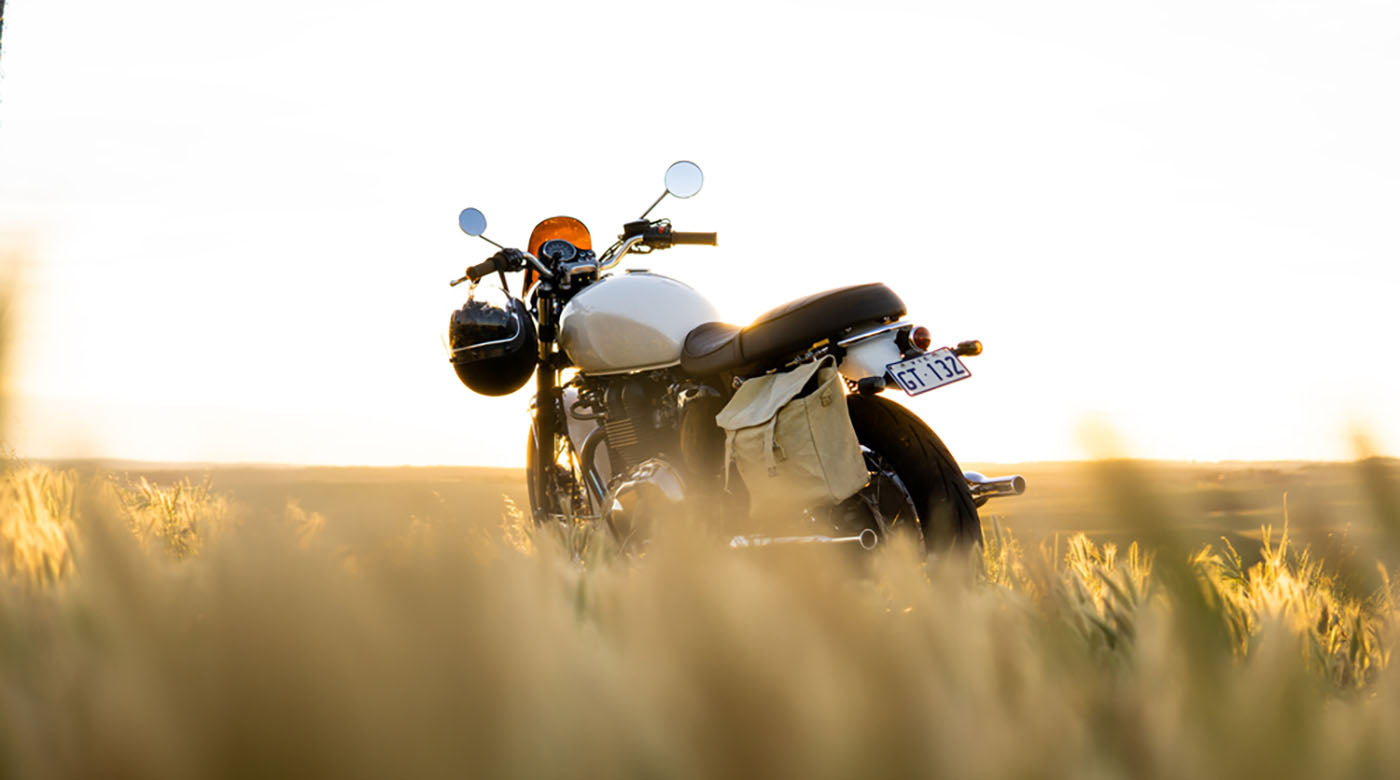 classic motorcycle parked in field