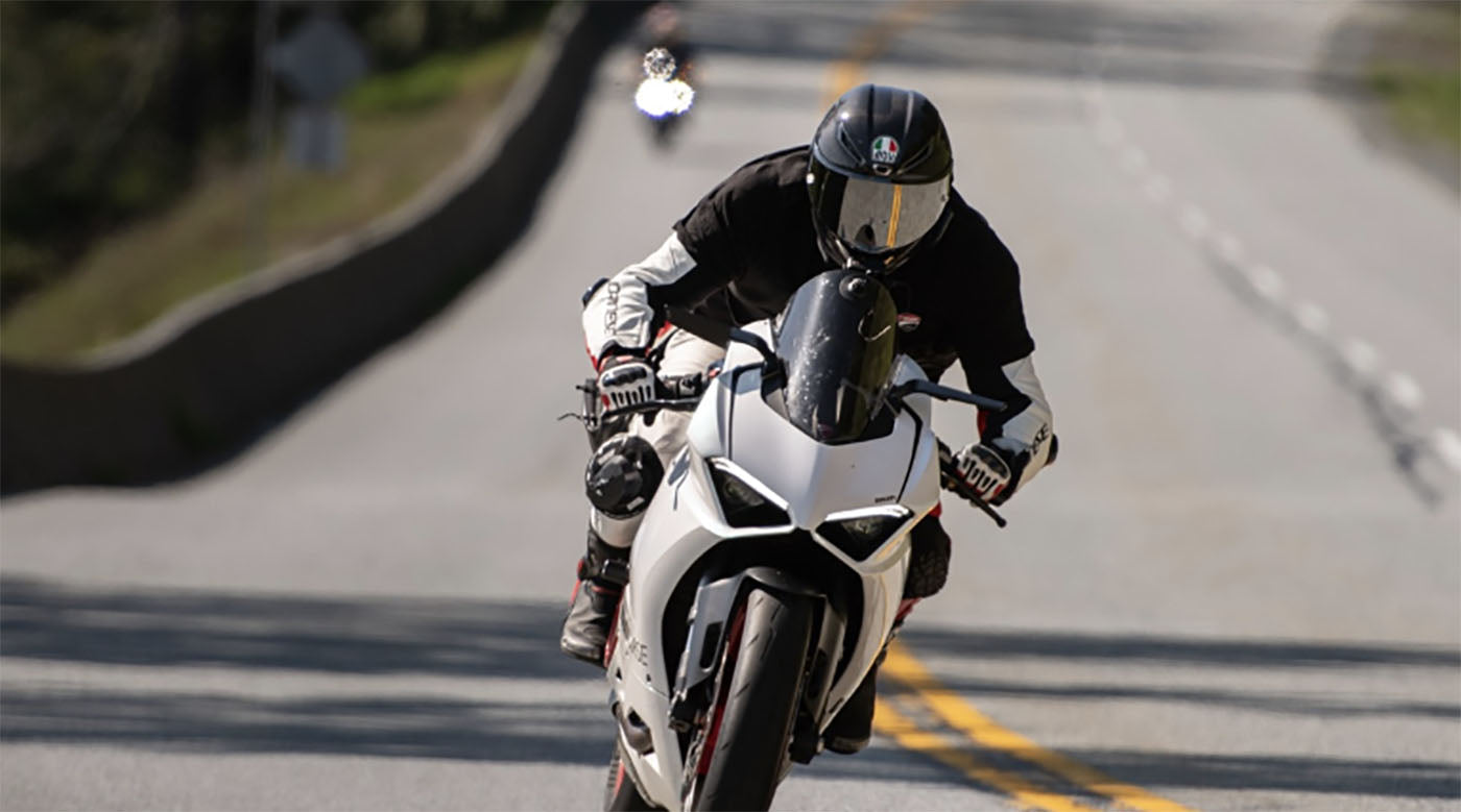 front view motorcyclist on winding road