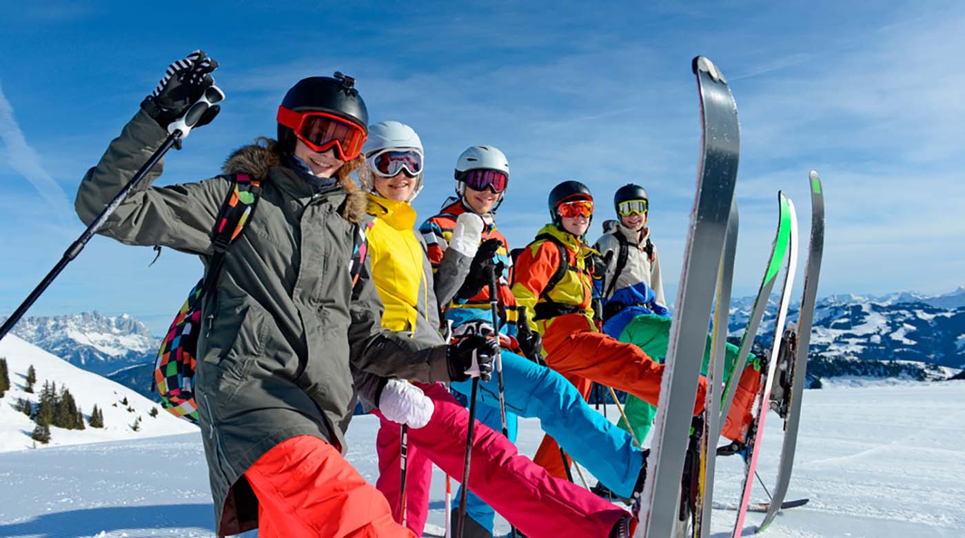 group shot of snowboarders holding gear