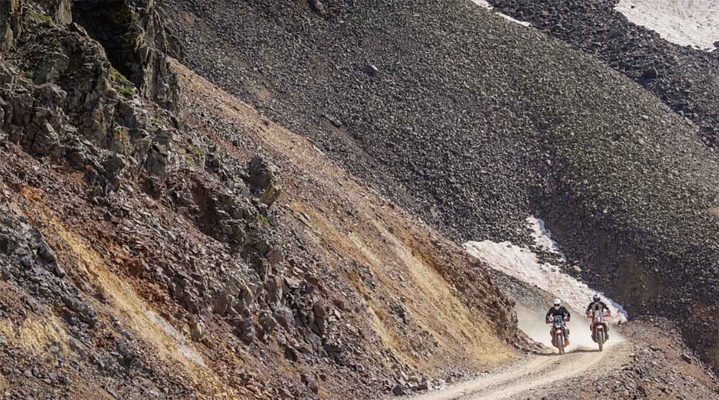 pair of bikers on winding road