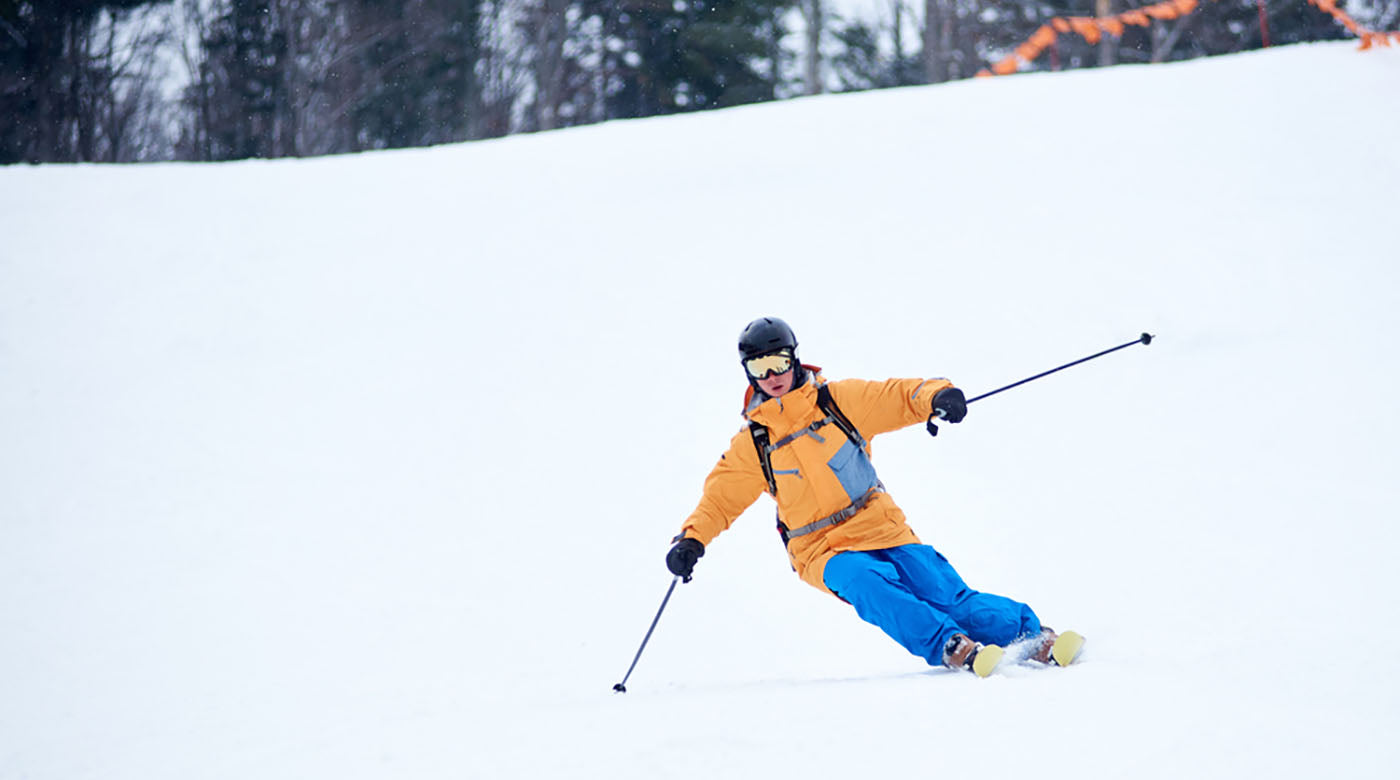 professional skier concentrated on skiing downhill