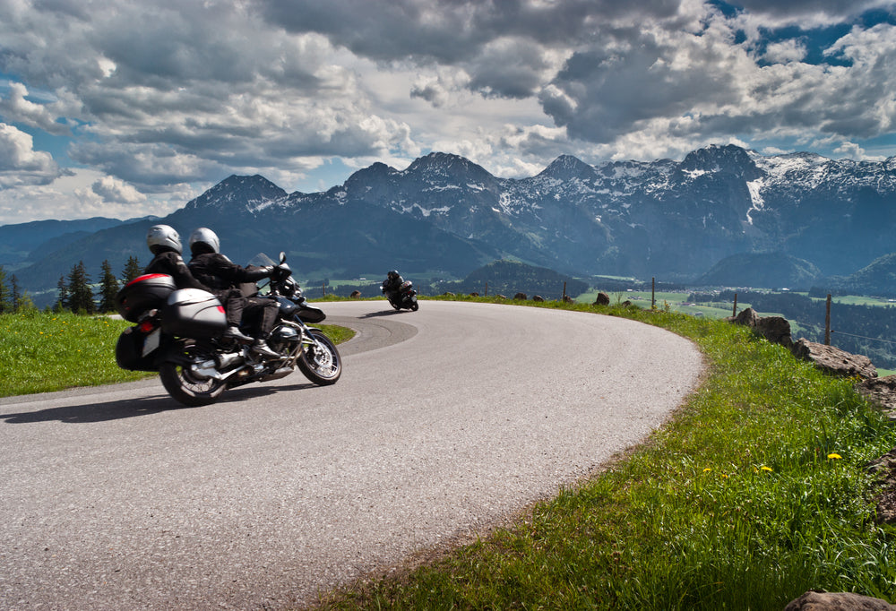 motorcycle riders riding through mountains