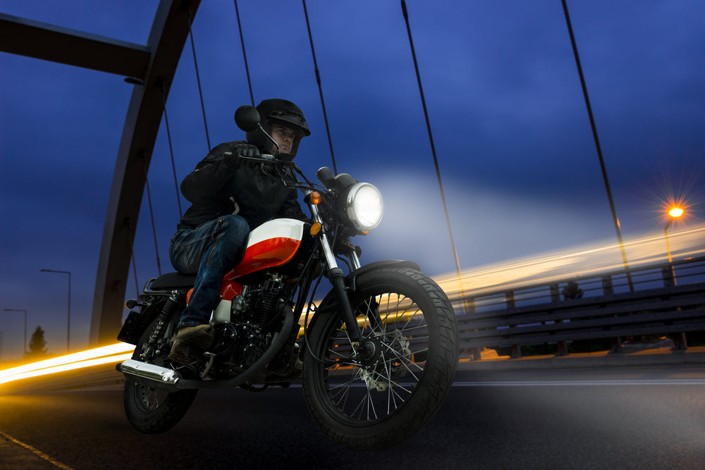man riding motorcycle at night