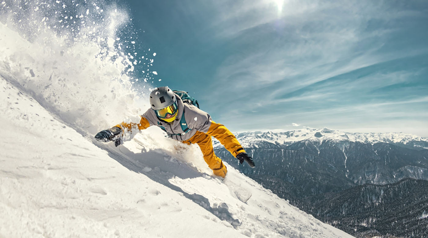 snowboarder riding off-piste ski slope