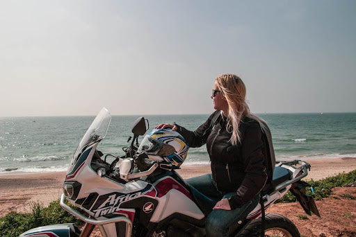 woman on motorcycle at beach