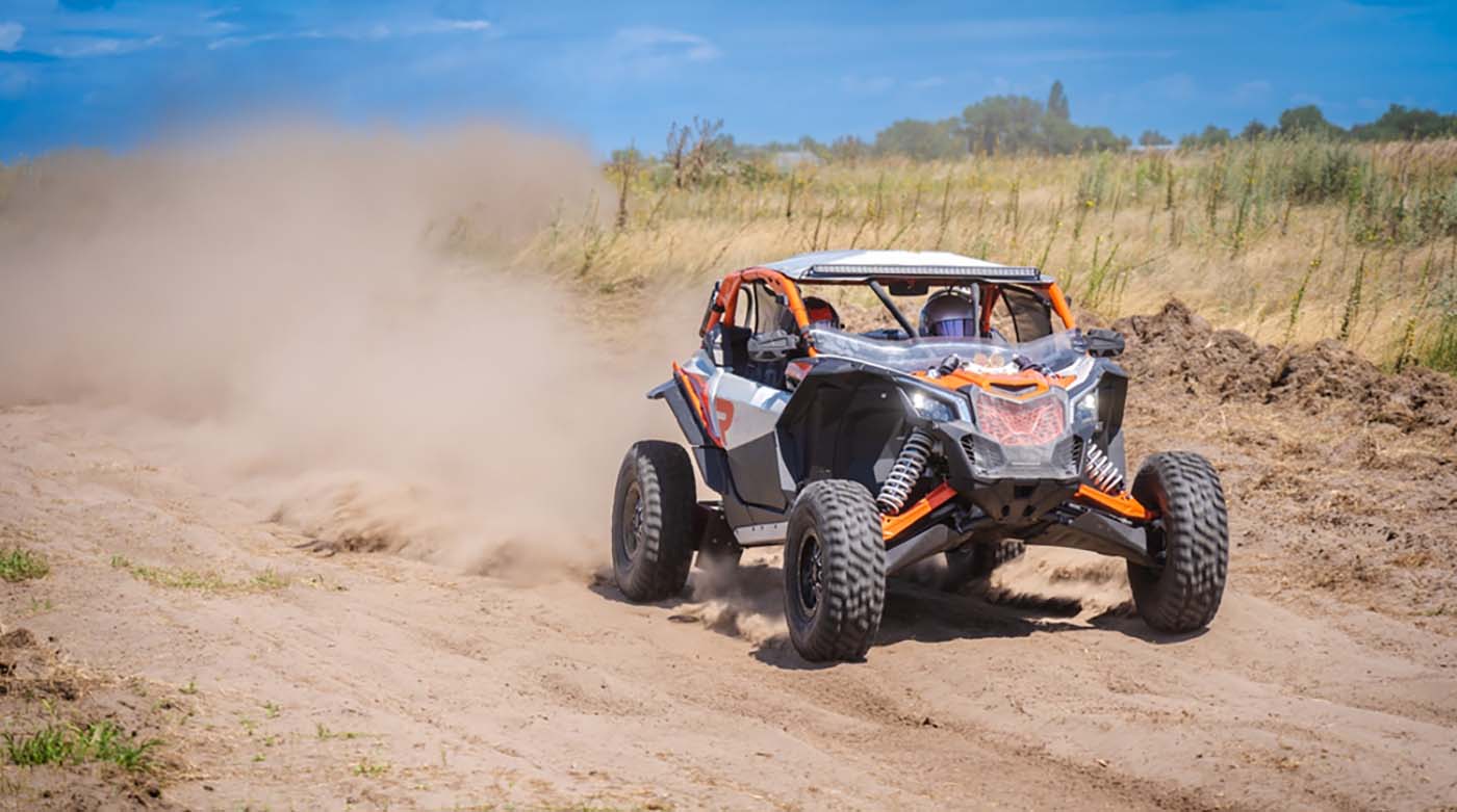 utv buggy driving on dirt road