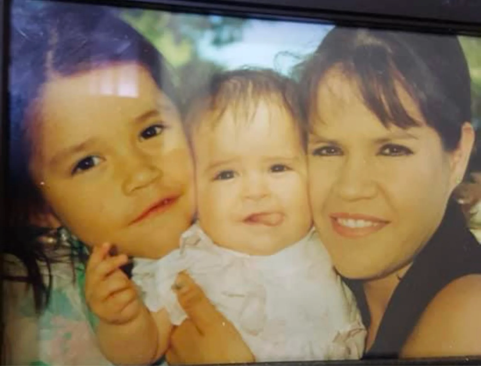A family photograph of Mar’s mother with two children.